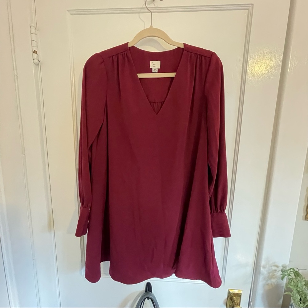 A New Day Flowy maroon dress with puffy shoulders and long sleeves size x-small
